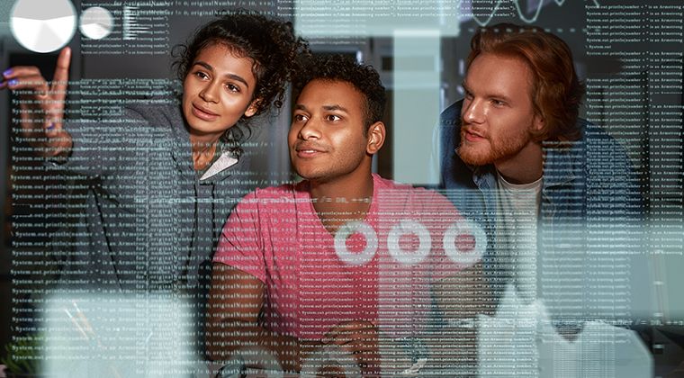 Three engineers facing the camera evaluate code