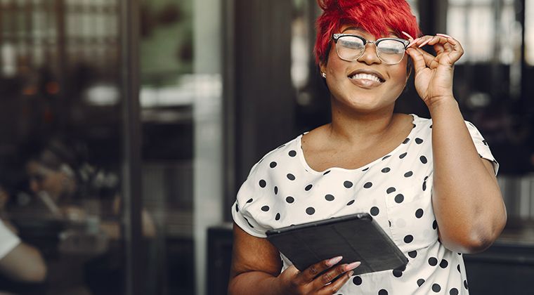 Girl with red hair and an iPad