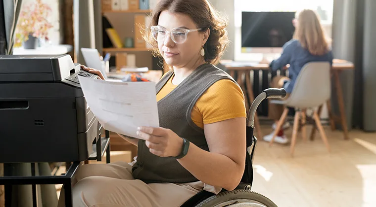 woman at a copier in a wheelchair